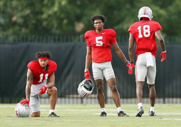 Ohio State Buckeyes wide receiver Marvin Harrison Jr. (18) gets a high five from wide receiver Garrett Wilson (5) after catching a pass during football training camp at the Woody Hayes Athletic Center in Columbus on Tuesday, Aug. 10, 2021. Ohio State Football Training Camp